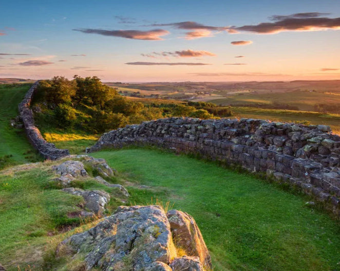 Hardians Stone wall ruins with a scenic landscape at sunset