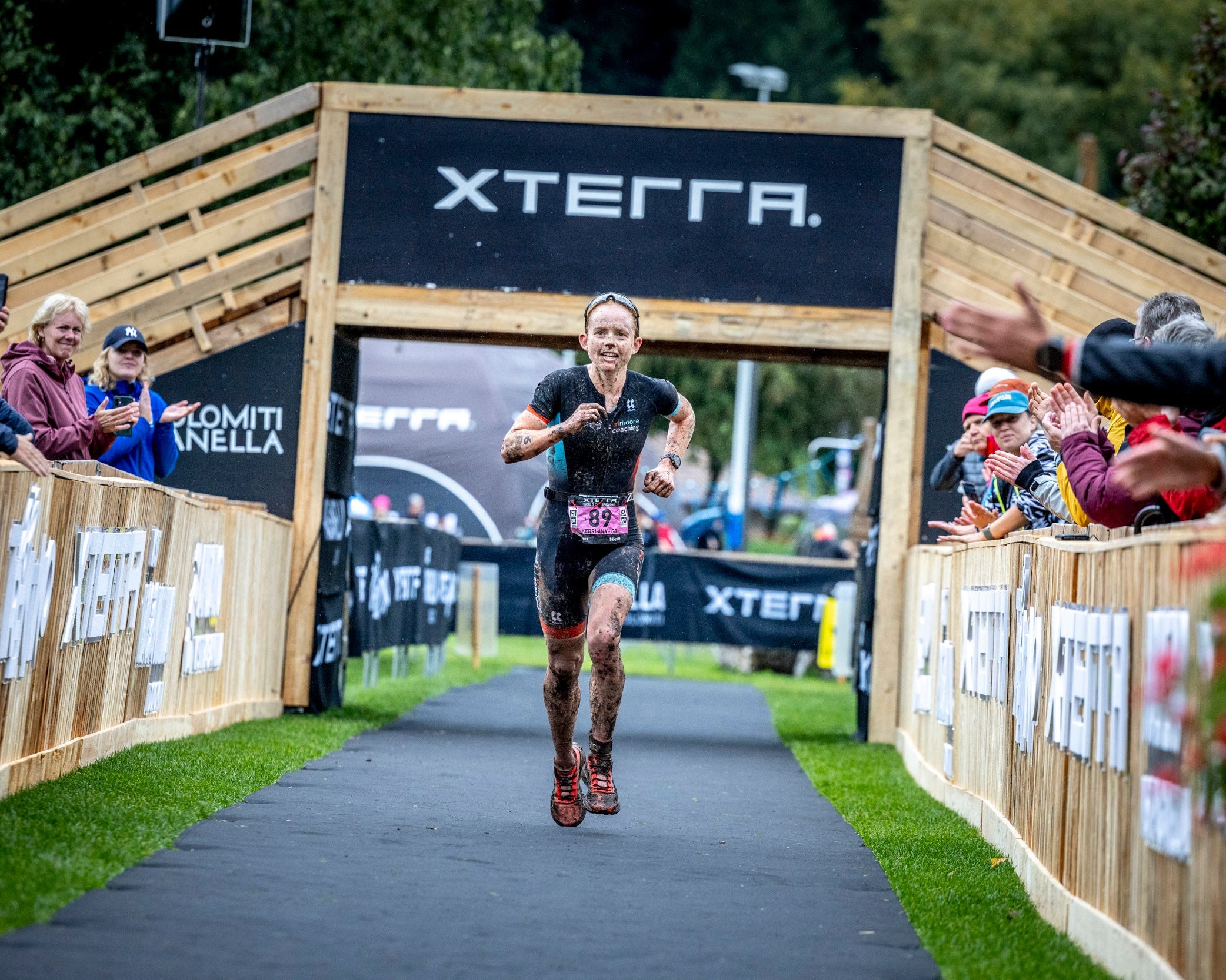Athlete running in a race with Xterra branding in the background
